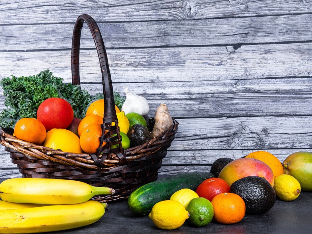 A vibrant and colorful assortment of fresh fruits neatly arranged in a wicker basket.